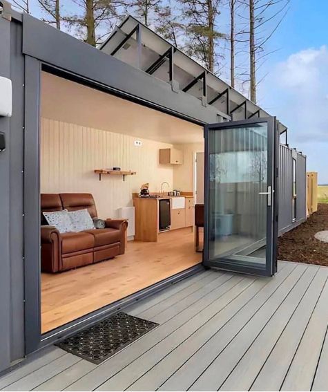 Casa modular con estructura metálica y puerta acristalada abierta